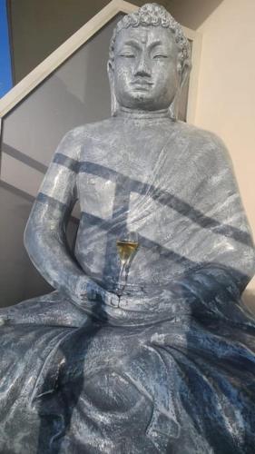 a statue of a man with a glass in his hand at Sea Side Calais vue mer in Calais