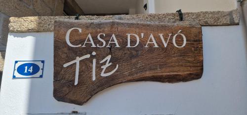 a wooden sign on the side of a building at Casa D'Avó Tiz in Avô