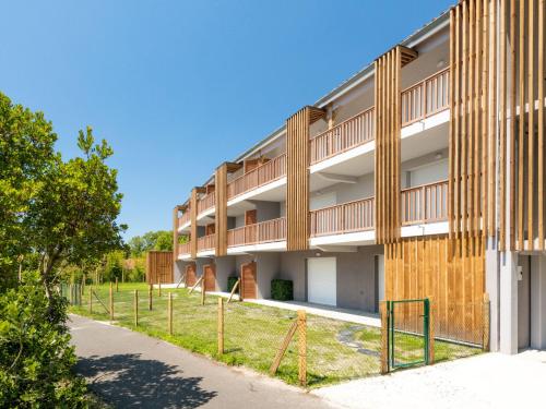 an external view of a building with a playground at Apartment Jade et Elena-2 by Interhome in Lit-et-Mixe