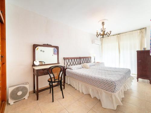 a bedroom with a bed and a mirror and a chair at Apartment Navio by Interhome in Aguadulce