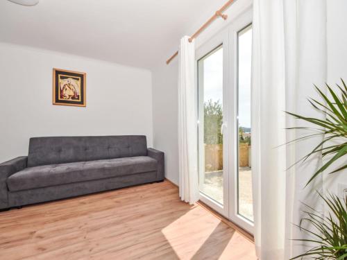 a living room with a couch and a sliding glass door at Holiday Home Goran II by Interhome in Sveti Filip i Jakov