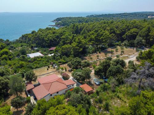 an aerial view of a house with trees and the ocean at Holiday Home Dundo House by Interhome in Rab