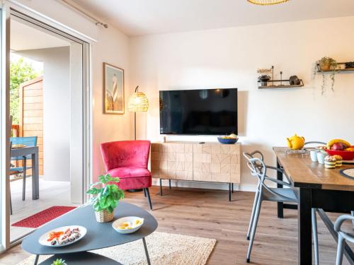 a living room with a table and a dining room at Apartment Jade et Elena-3 by Interhome in Lit-et-Mixe