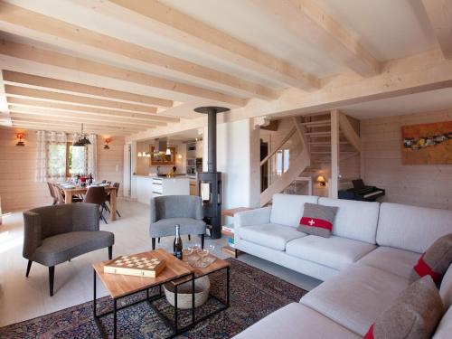 a living room with a couch and a table at Chalet Chalet Domino by Interhome in Chesières