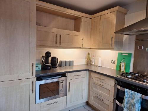 a kitchen with white cabinets and a stove top oven at Stratford-upon-Avon 1-Bed Sleeps 4 Pets Allowed in Stratford-upon-Avon