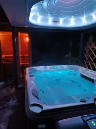 a jacuzzi tub in a room with blue lighting at Apartment Panorama Gerlitzen in Treffen