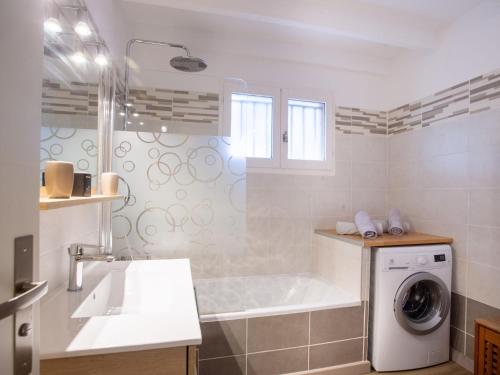 une salle de bain avec une machine à laver et un lavabo dans l'établissement Holiday Home Jean d'Agreve-1 by Interhome, à Hyères