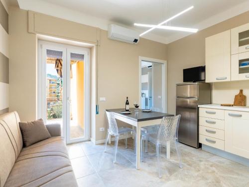 a living room with a couch and a table and a kitchen at Apartment Nives by Interhome in Diano Marina