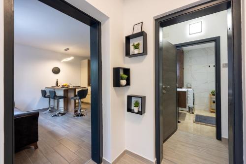a hallway with a door leading into a room with a table at Nika in Crikvenica