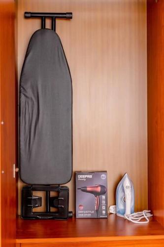 a shelf with a microwave and a box on a table at The beautiful Shams AO9 in Entebbe