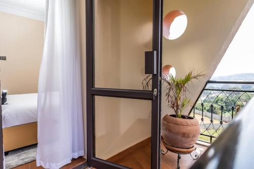 a room with a glass door with a potted plant at The beautiful Shams AO9 in Entebbe