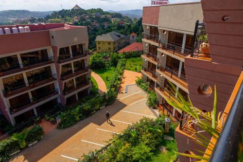 a person walking down a street between two buildings at The beautiful Shams AO9 in Entebbe