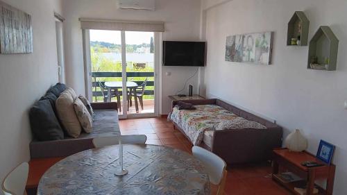 a living room with a couch and a table at Hello Sun in Vilamoura