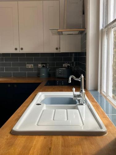 a kitchen with a white sink in a kitchen at Crown Cove in Pakefield