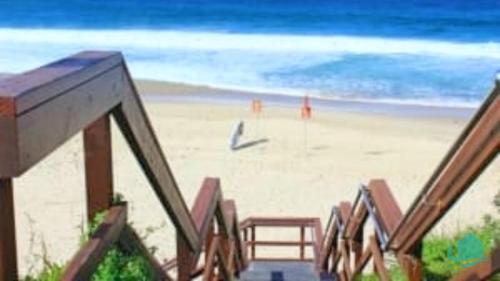 a view of the beach from a balcony at By the Beach at Catho in Catherine Hill Bay