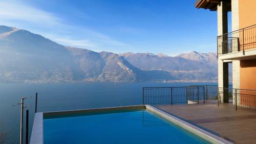 a swimming pool with a view of the mountains at Residence Dorio in Dorio