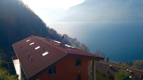 a house with a red roof next to the water at Residence Dorio in Dorio