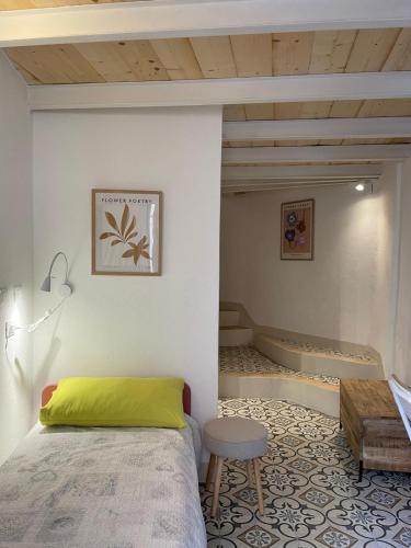 a bedroom with a bed and a table and a stool at Torre Anna Red in Riomaggiore