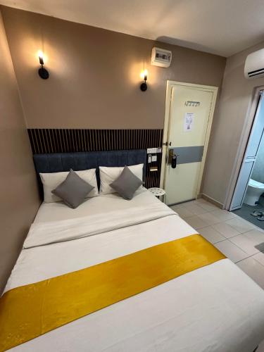 a bedroom with a large bed with white sheets and pillows at SS Grey Hotel 2 in Kuala Lumpur