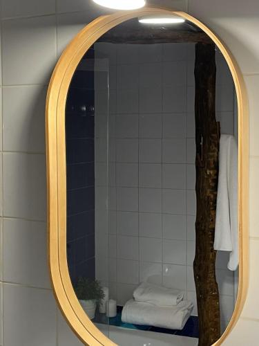 a mirror in a bathroom with a tree at El Encanto de Bustares in Bustares