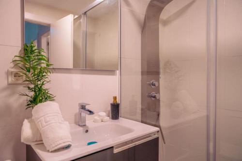a white bathroom with a sink and a shower at SPA HOUSE SIERRA NEVADA by JB in Monachil