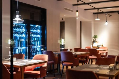 a dining room with tables and chairs and lights at Aktivhotel Santalucia in Nago-Torbole
