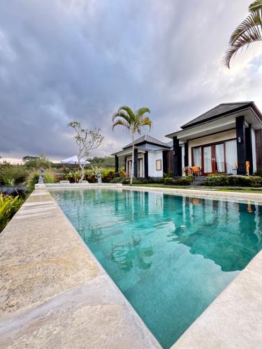 an image of a swimming pool in front of a house at Bali Astetic Villa and Hot Spring in Kintamani