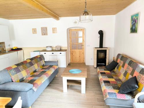 a living room with two couches and a kitchen at U Modré hvězdy, chalupa Svratka in Svratka