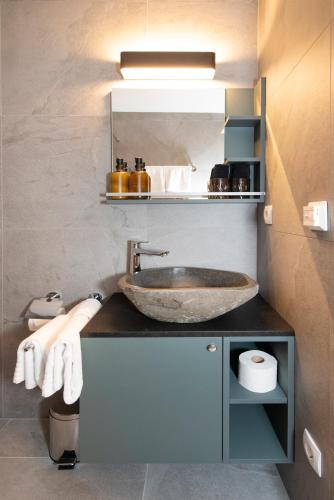 a bathroom with a sink and a mirror at Natural Deluxe Apartments Alpbach in Alpbach