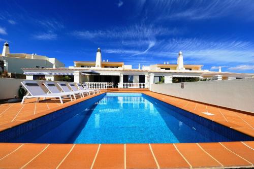 a swimming pool on the roof of a house at Bela Vivenda-pretty Family Villa With Pool & Golf in Castro Marim