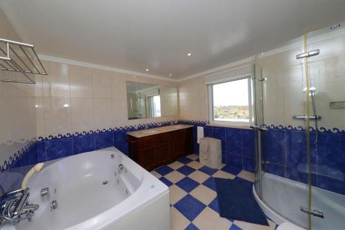 a bathroom with a tub and a shower and a sink at Bela Vivenda-pretty Family Villa With Pool & Golf in Castro Marim