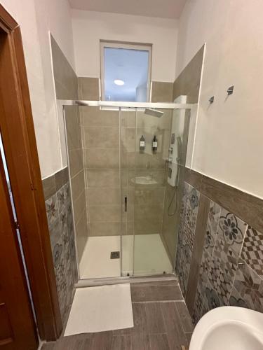 a bathroom with a shower and a toilet at Maison Margot in Pozzuoli