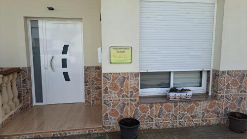 a front door of a house with a window at Lo de Joel in Els Muntells