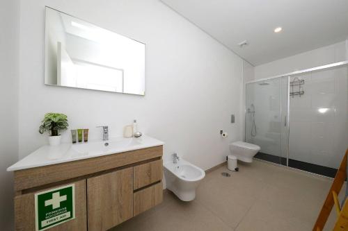 a bathroom with a sink and a toilet and a shower at Casa Emeline-stunning Family Villa With Pool in Tavira