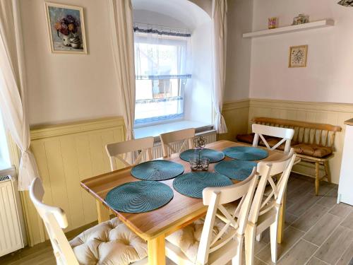 a dining room with a wooden table and chairs at U Modré hvězdy, chalupa Svratka in Svratka