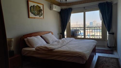A bed or beds in a room at Nile House