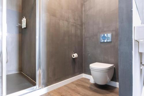 a bathroom with a shower and a toilet at 1881 Hotel Balneario Vichy Catalan in Caldes de Malavella