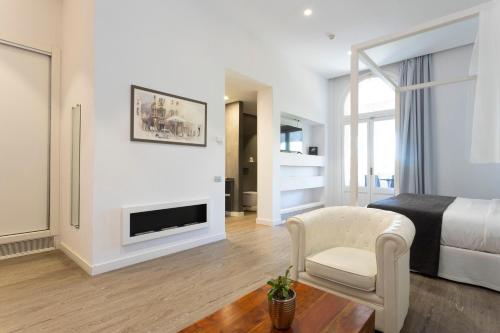 a living room with a bed and a fireplace at 1881 Hotel Balneario Vichy Catalan in Caldes de Malavella