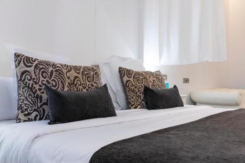 a large white bed with pillows on top of it at 1881 Hotel Balneario Vichy Catalan in Caldes de Malavella