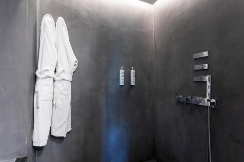 a bathroom with white towels hanging on a wall at 1881 Hotel Balneario Vichy Catalan in Caldes de Malavella