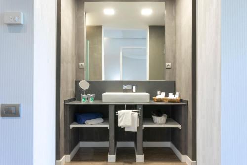 a bathroom with a sink and a mirror at 1881 Hotel Balneario Vichy Catalan in Caldes de Malavella