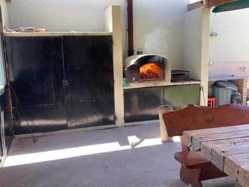 a kitchen with a pizza oven in a room at BIG FISH El Cóndor in Balneario El Condor