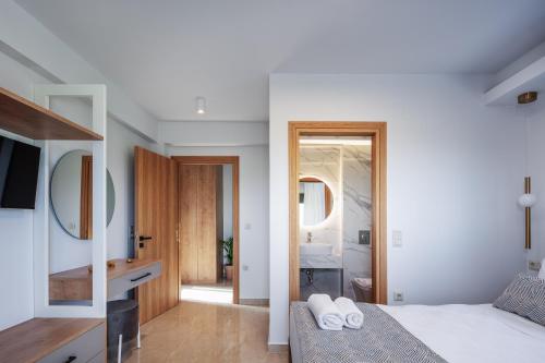 a bedroom with a bed and a sink and a mirror at Garde Villa, with Private Pool, BBQ & Playground, By ThinkVilla in Roumelí