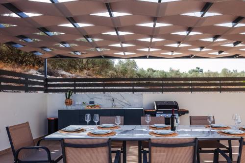 a dining room with a table and chairs at Garde Villa, with Private Pool, BBQ & Playground, By ThinkVilla in Roumelí