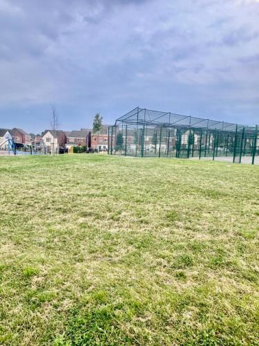 a large field with a large glass building at Spacious 4-Bed House Close to City Centre in Wolverhampton