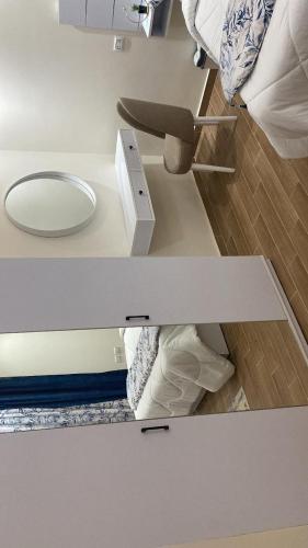 a room with a bed and a mirror on a table at H Flat With Roof- One Kattamya in Cairo