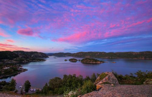 a view of a river at sunset with pink clouds at Stunning Home In Lyngdal With Kitchen in Lyngdal