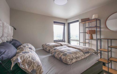 a bedroom with two beds and a window at Stunning Home In Lyngdal With Kitchen in Lyngdal