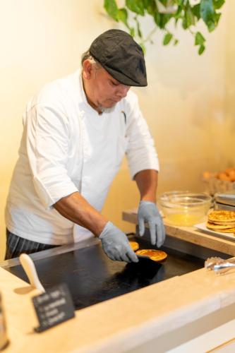 a man is preparing food in a kitchen at Borgo San Luigi in Monteriggioni