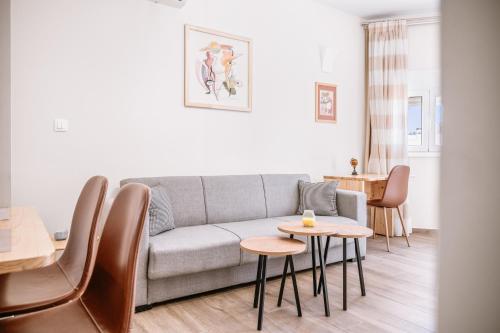 a living room with a couch and a table at CityView 2 fully equipped apt by Hospi in Heraklio Town